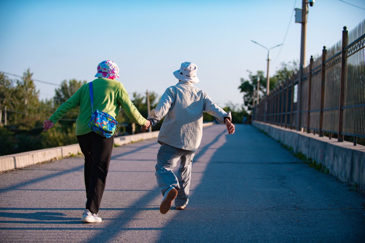 Senior couple walking hand in hand outdoors